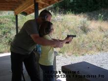 Scott teaches young student firearm safety on the range